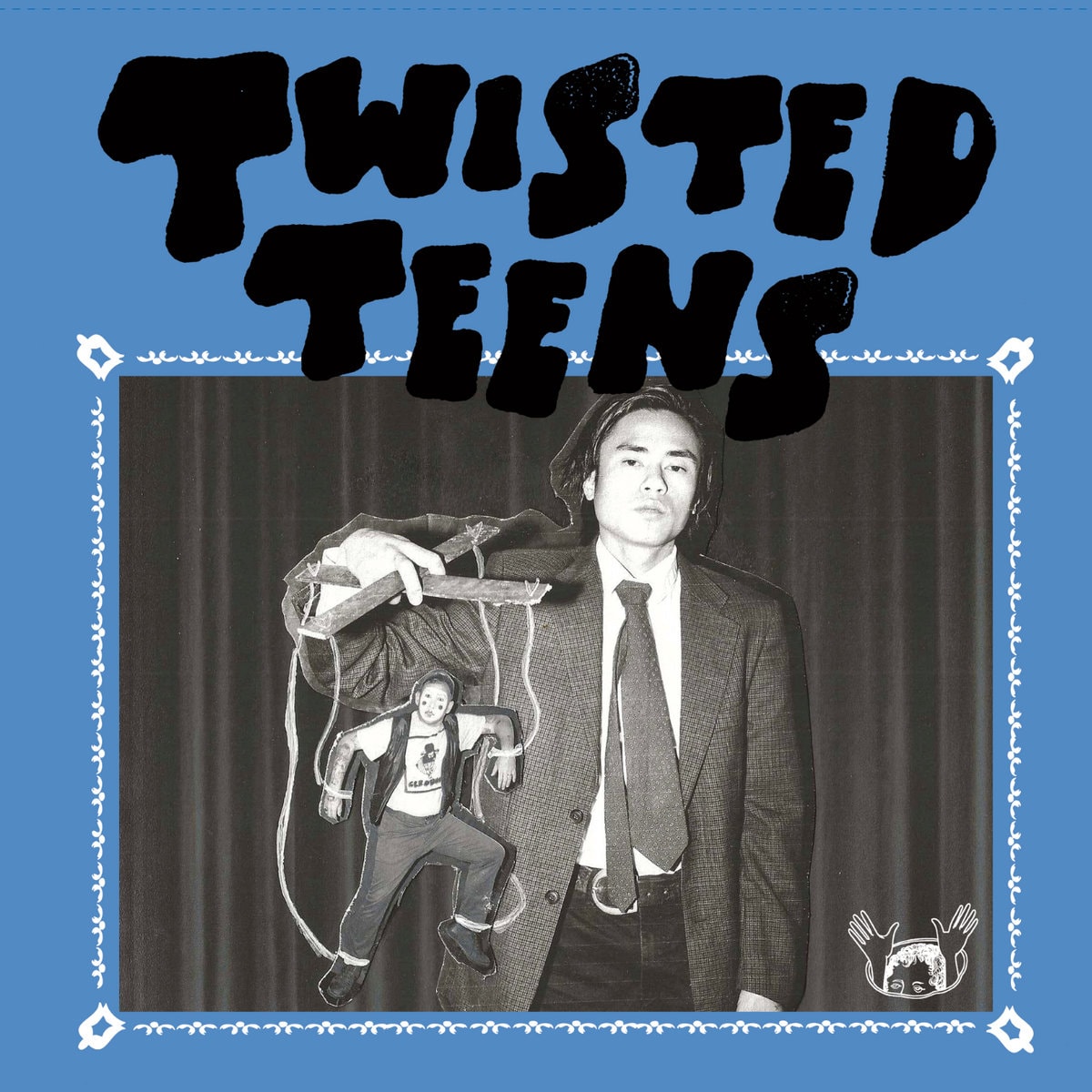 Blue Twisted Teens cover: a black-and-white photo of a man in a suit and tie holding up a marionette-style cut-out of a clown-faced figure